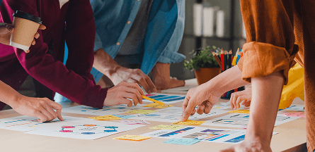 People moving sticky notes